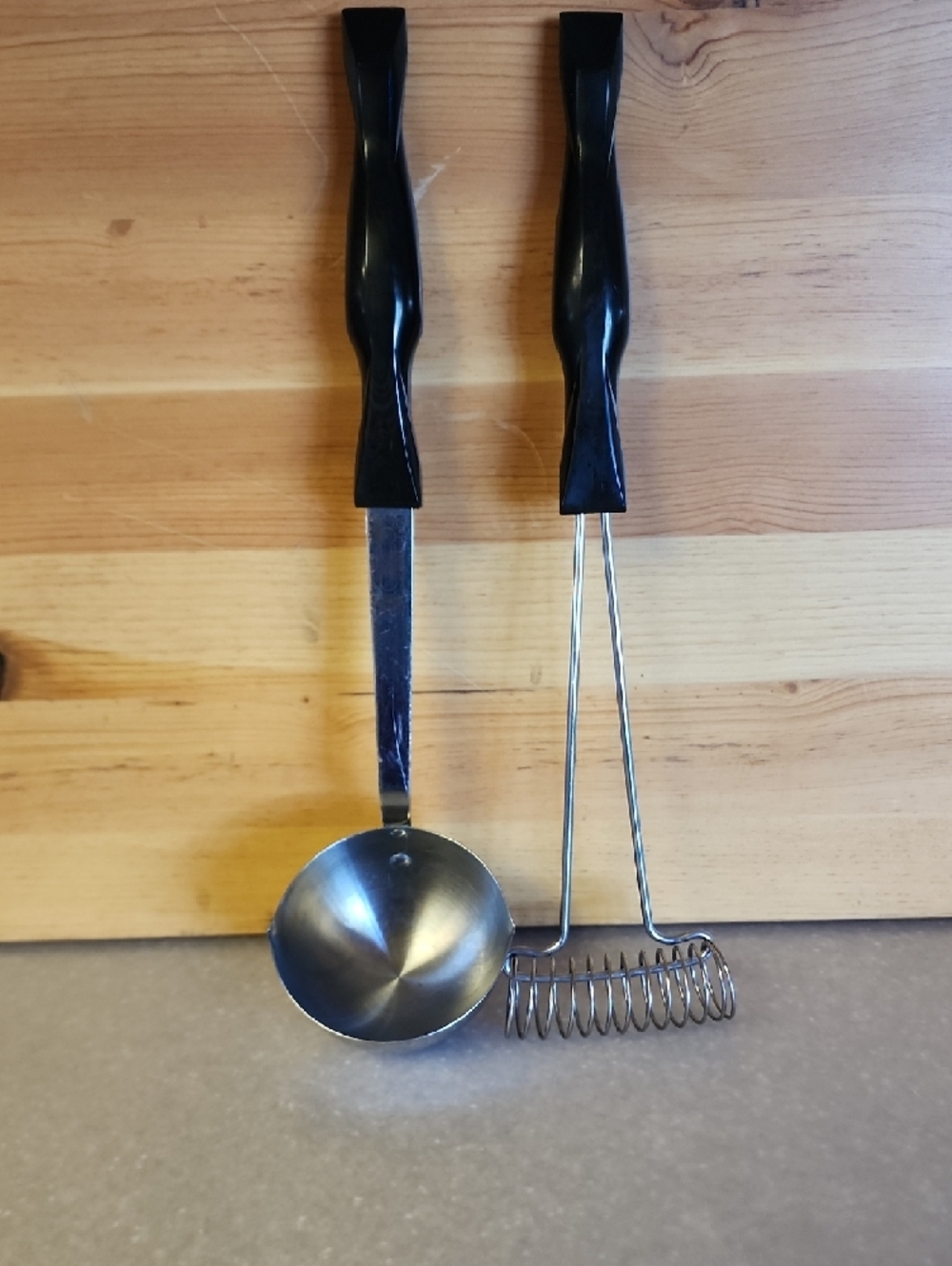 Cutco, Black Handle Stainless Steel Ladle and Masher Set.